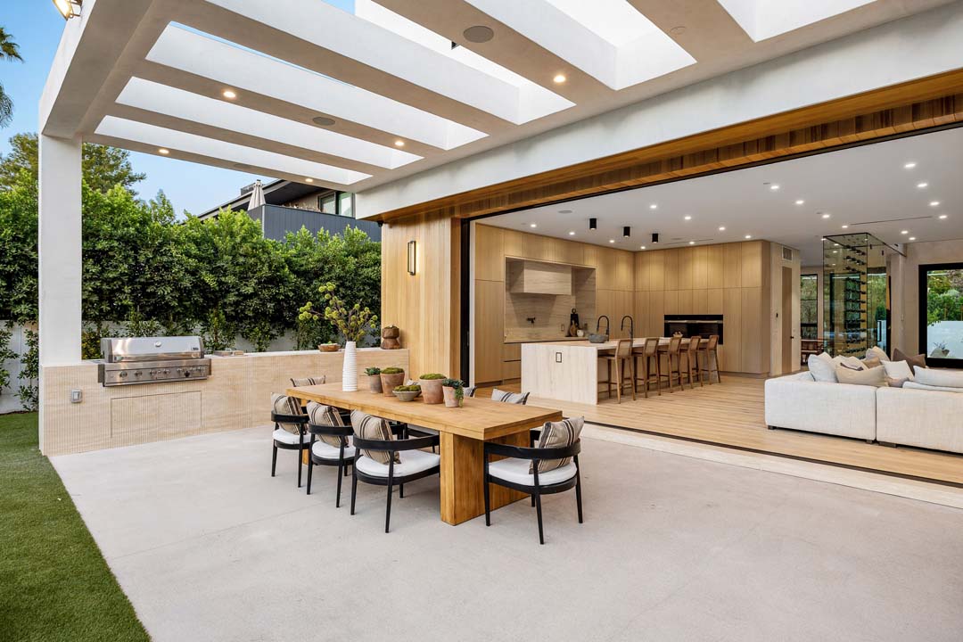 Modern open-plan kitchen and outdoor dining area.